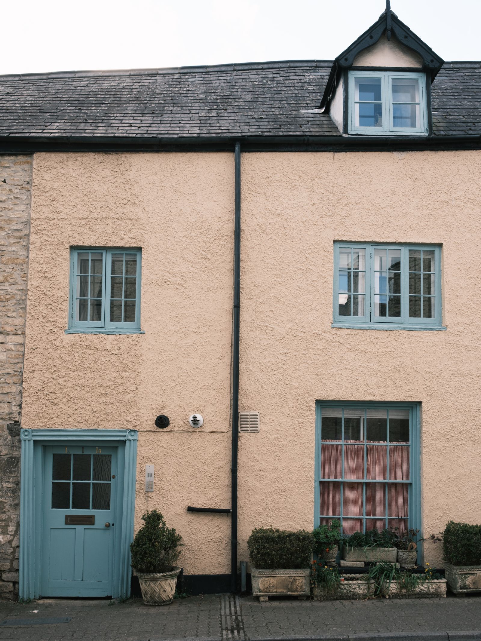 Charming cottage with a newly fitted blue front door and matching windows